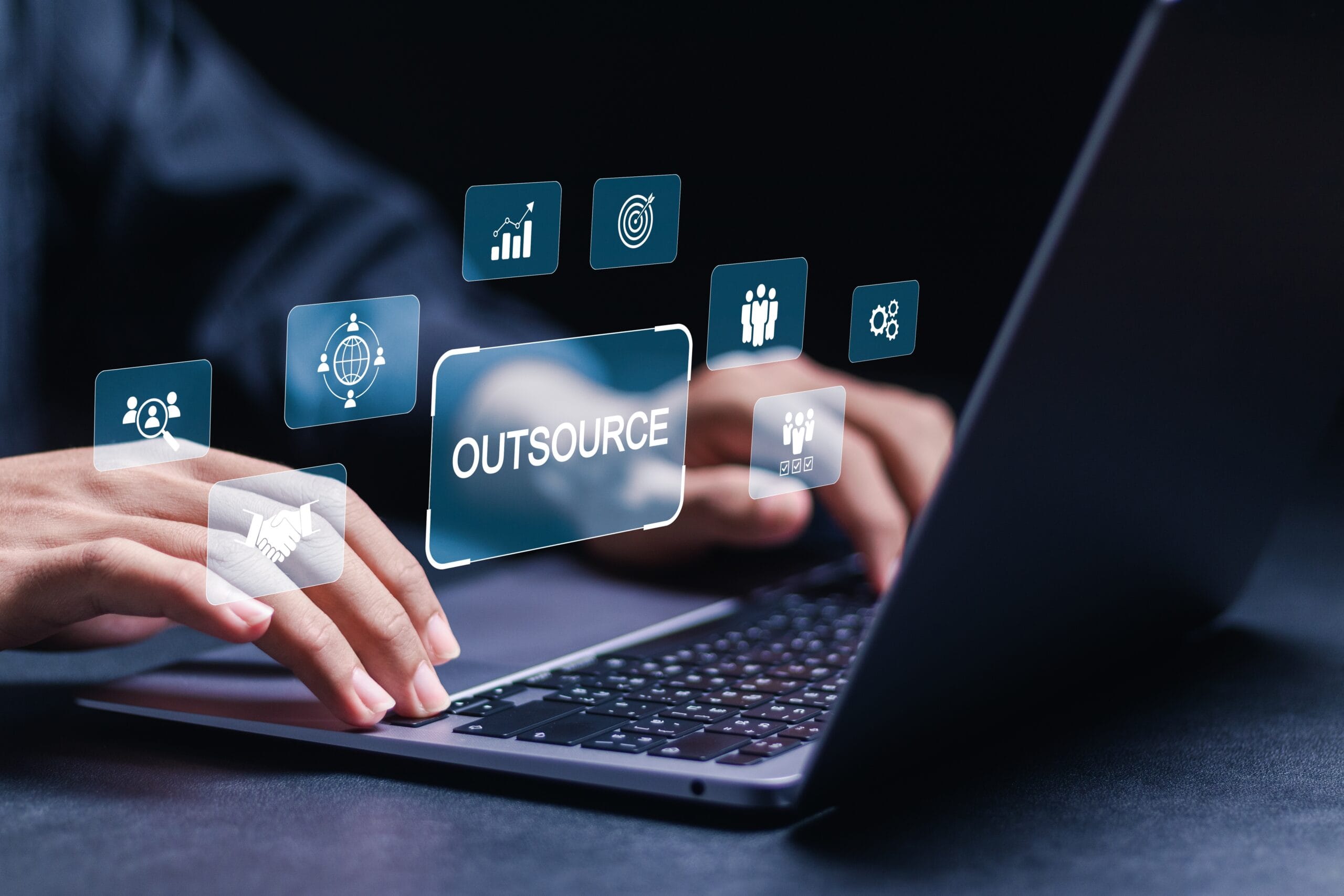 Person at laptop with floating marketing icons