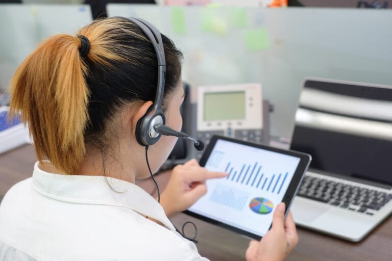Person with headset looking at tablet of data.